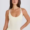 Bodis de jersey de algodón elástico con espalda cruzada en capas en color crema