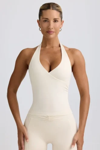 Camiseta sin mangas con cuello halter y espalda abierta en marfil jaspeado