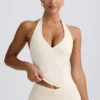 Camiseta sin mangas con cuello halter y espalda abierta en marfil jaspeado