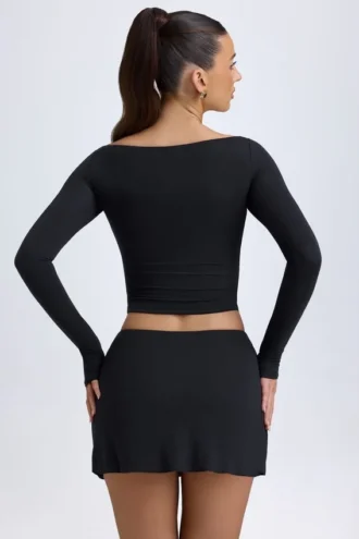 Falda de talle bajo con detalle de botones en modal «Dalla» en negro