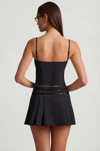 Falda plisada de talle bajo con cinturón Velora en negro