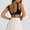 Mini falda-pantalón plisada con cruce, de tejido suave y deportivo, en color marfil