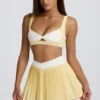 Mini falda-pantalón plisada cruzada Soft Active en color limón