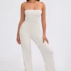 Mono bandeau de punto grueso con pantalones acampanados en color crema