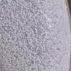 Mono con aberturas y adornos Coralena en blanco