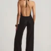 Mono Tulay de devoré con cuello halter y espalda abierta en negro