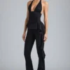 Pantalones acampanados de talle bajo con volantes metalizados Reese en negro