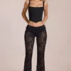 Pantalones acampanados de talle medio de encaje transparente Calista en negro