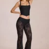 Pantalones acampanados de talle medio de encaje transparente Calista en negro