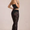 Pantalones acampanados de talle medio de encaje transparente Calista en negro