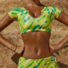 Pantalones cortos de ropa de baño Delos Booty con estampado verde