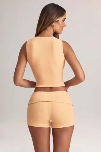 Pantalones Cortos Nina de modal con vuelta y talle medio en color melocotón