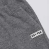 Pantalones de chándal de algodón texturizado con botones, de talle bajo y pierna ancha en gris oscuro