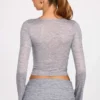 Partes de arriba de manga larga con escote pronunciado de jersey transparente Liah en gris