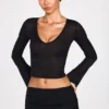 Partes de arriba largas de manga larga con escote pronunciado de jersey transparente Liah en negro