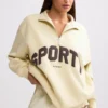 Sudadera con cremallera de un cuarto en color hueso
