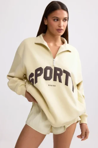 Sudadera con cremallera de un cuarto en color hueso