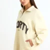 Sudadera con cremallera de un cuarto en color hueso