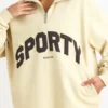 Sudadera con cremallera de un cuarto en color hueso