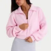 Sudadera corta con cremallera de punto acanalado en rosa pálido