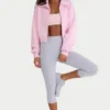 Sudadera corta con cremallera de punto acanalado en rosa pálido