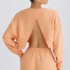Sudadera corta con espalda abierta de jersey de algodón texturizado en color melocotón