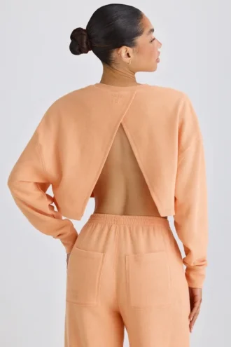 Sudadera corta con espalda abierta de jersey de algodón texturizado en color melocotón
