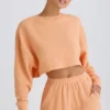 Sudadera corta con espalda abierta de jersey de algodón texturizado en color melocotón