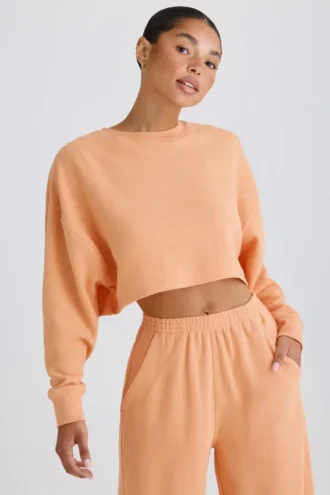Sudadera corta con espalda abierta de jersey de algodón texturizado en color melocotón