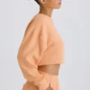Sudadera corta con espalda abierta de jersey de algodón texturizado en color melocotón