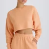 Sudadera corta con espalda abierta de jersey de algodón texturizado en color melocotón