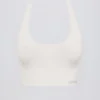 Sujetador deportivo Define Luxe con cuello halter en blanco