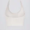 Sujetador deportivo Define Luxe con cuello halter en blanco