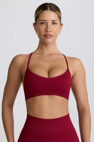 Sujetador deportivo sin costuras con espalda cruzada Super Sculpt en color burdeos