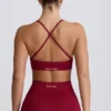 Sujetador deportivo sin costuras con espalda cruzada Super Sculpt en color burdeos