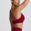 Sujetador deportivo sin costuras con espalda cruzada Super Sculpt en color burdeos
