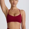 Sujetador deportivo sin costuras con espalda cruzada Super Sculpt en color burdeos