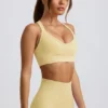 Sujetador deportivo sin costuras Super Sculpt con espalda cruzada en amarillo mantequilla