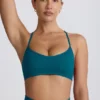 Sujetador deportivo sin costuras Super Sculpt con espalda cruzada en color verde azulado