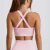 Sujetador deportivo sin costuras Super Sculpt con espalda cruzada en rosa empolvado