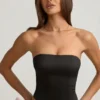 Top corsé con aberturas y lazo Audrina en negro