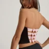 Top corsé con aberturas y lazo Audrina en negro