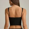 Top corsé con aberturas y lazo Pearla en negro