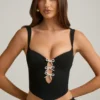Top corsé con aberturas y lazo Pearla en negro