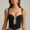 Top corsé con aberturas y lazo Pearla en negro