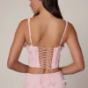Top corsé con cordones y adornos Letitia en rosa suave