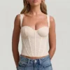 Top corsé de encaje con aros Junia en color marfil