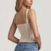 Top corsé de encaje con aros Junia en color marfil