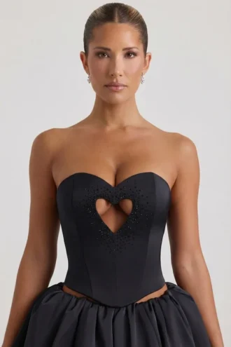 Top corsé sin tirantes con aberturas y corazones decorativos Amora en negro
