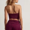 Top corto bandeau Tarni con detalles metálicos en morado baya